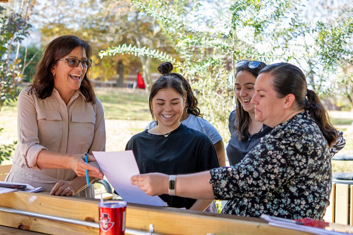 Angela Stone (left), a reading instructor in the Eriksson College of Education, interacts with students on campus at Austin Peay State University. Her intentional course design contributed to APSU achieving the highest first-time pass rate on the Tennessee Early Literacy Assessment. (Jaylon Gonzales, APSU)