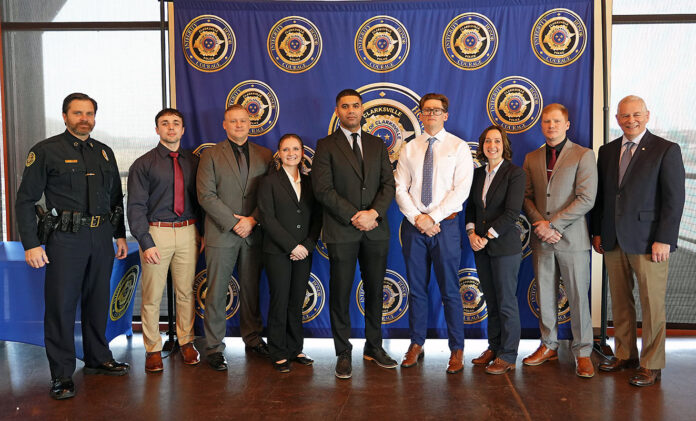 (L-R) Clarksville Police Chief Ty Burdine, Lance Doyle, William Lomax, Layne Schelest, Ioannis Sanchez, Ian Santos, Lauren Sykes, Justin Tippy, and Clarksville Mayor Joe Pitts.