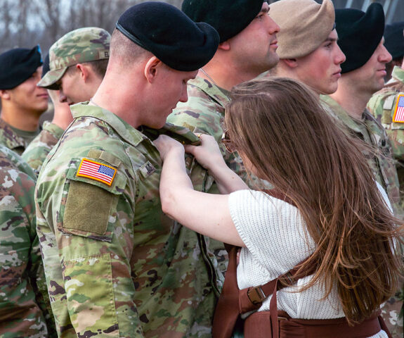 U.S. Army Spc. Hunter Wade, an infantryman assigned to the 101st Airborne Division (Air Assault), is pinned his Air Assault Badge by his wife during air assault school graduation at Fort Campbell, KY, March 3rd, 2026. (Staff Sgt. Raymond Valdez)