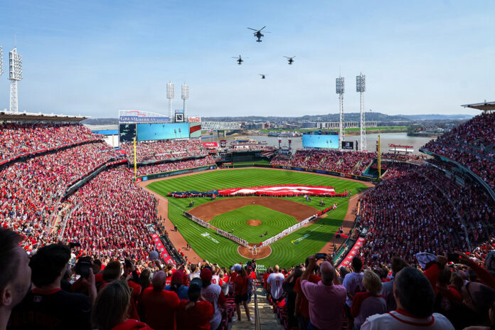 U.S. Army AH-64 Apache helicopters assigned to 1st Battalion, 101st Aviation Regiment “No Mercy,” alongside a UH-60 Black Hawk from 5th Battalion, 101st Aviation Regiment “Eagle Assault,” conduct a flyover above Great American Ball Park in Cincinnati, Ohio, during Opening Day ceremonies for the Cincinnati Reds, March 26, 2026. The flyover honored the longstanding partnership between the military and local community while showcasing the speed, precision, and readiness of Army aviation units from the 101st Combat Aviation Brigade. (Courtesy of the Cincinnati Reds)