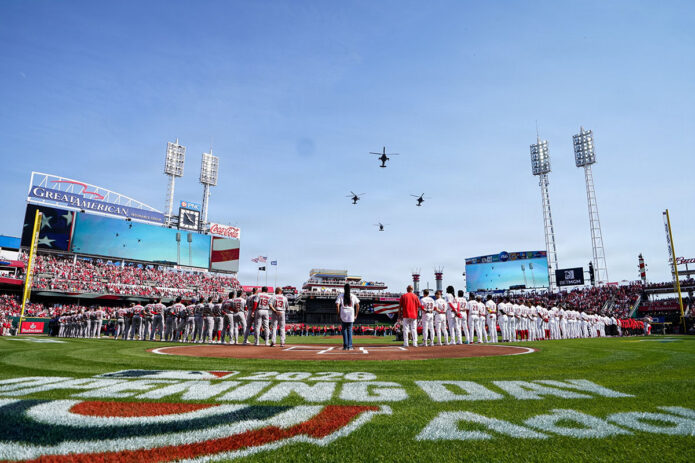 U.S. Army AH-64 Apache helicopters assigned to 1st Battalion, 101st Aviation Regiment “No Mercy,” alongside a UH-60 Black Hawk from 5th Battalion, 101st Aviation Regiment “Eagle Assault,” conduct a flyover above Great American Ball Park in Cincinnati, Ohio, during Opening Day ceremonies for the Cincinnati Reds, March 26, 2026. The flyover honored the longstanding partnership between the military and local community while showcasing the speed, precision, and readiness of Army aviation units from the 101st Combat Aviation Brigade. (Courtesy of the Cincinnati Reds) 