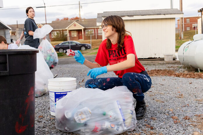 Amberthest Wertanen, AmeriCorps VISTA sustainability specialist, works with the Austin Peay State University Recycling Team after the November 16th, 2025 home football game. (Kaos Armstrong, APSU)