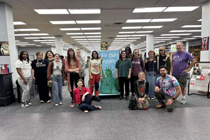 Austin Peay State University students, faculty, and staff with the “We the People” book installation, part of the Unbannable Library. Four Department of Art + Design students collaborated on the piece. (Contributed photo)