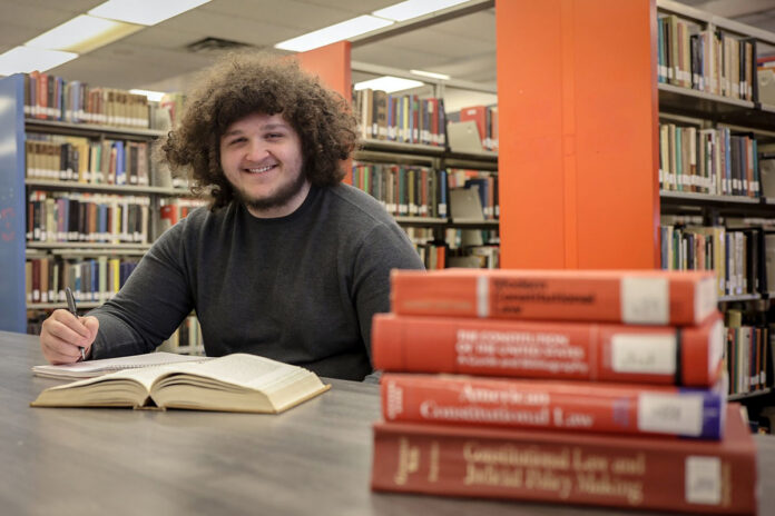 Austin Peay State University political science student Noah Janecek poses inside Felix G. Woodward Library. Janecek recently earned a $90,000 scholarship to attend Lincoln Memorial University Duncan School of Law through APSU’s accelerated 3+3 program. (Seth Riker, APSU)