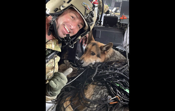 Sgt. 1st Class John Sharbel, a flight paramedic with the Tennessee Army National Guard’s 1-230th Assault Helicopter Battalion, takes a photograph with Jack, a German Shepherd, just after being hoisted into a Blackhawk helicopter during a rescue after being trapped in a ravine with his owner overnight in the Cherokee National Forest, May 2nd. (submitted photo) 