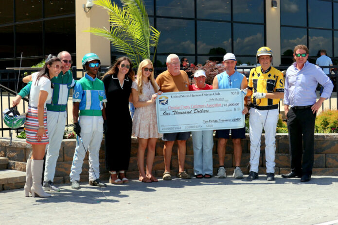 Members of the United States Harness Drivers Club present a $1,000 check to the Christian County Cattlemen's Association during Monday's charity race at Oak Grove Racing, Gaming & Hotel. (Mark Haynes, Clarksville Online)
