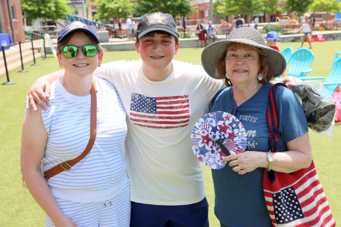 A young trivia champion celebrates after winning multiple America 250 patriotic ball caps for himself and his family during Joe Padula's Patriotic Trivia at Downtown Commons, adding to the fun and excitement of Clarksville-Montgomery County's America's 250th Celebration. (Mark Haynes, Clarksville Online)