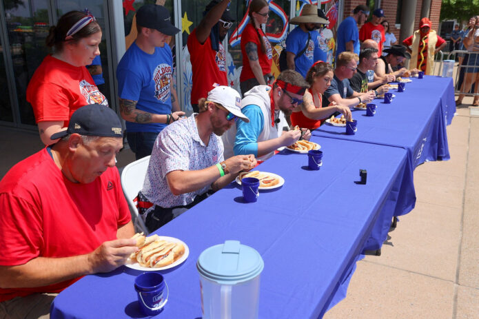 Contestants race against the clock during the inaugural Lowe's Hot Dog Eating Contest at Downtown Commons, battling to see who could eat the most hot dogs during Clarksville-Montgomery County's America's 250th Celebration. (Mark Haynes, Clarksville Online)
