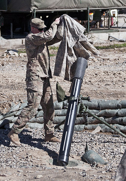 U.S. Army Sgt. Samuale Skogen, a mortarman with Company C, 3rd Battalion, 187th Infantry Regiment, 3rd Brigade “Rakkasans,” 101st Airborne Division (Air Assault), pulls a rain cover off a 120 mm mortar tube during a training exercise, March 1, 2013, at Combat Outpost Bowri Tana. The mortar section conducts drills daily to ensure they can be ready to fire quickly when called upon. (U.S. Army Photo by Spc. Alex Kirk Amen, 115th Mobile Public Affairs Detachment) U.S. Army Sgt. Samuale Skogen, a mortarman with Company C, 3rd Battalion, 187th Infantry Regiment, 3rd Brigade “Rakkasans,” 101st Airborne Division (Air Assault), pulls a rain cover off a 120 mm mortar tube during a training exercise, March 1, 2013, at Combat Outpost Bowri Tana. The mortar section conducts drills daily to ensure they can be ready to fire quickly when called upon. (U.S. Army Photo by Spc. Alex Kirk Amen, 115th Mobile Public Affairs Detachment)