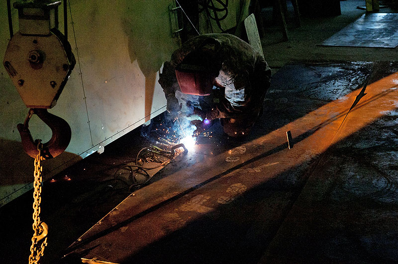 Spc. Joshua Finley, E Troop, 2nd Squadron, 17th Cavalry Regiment allied trade specialist, a native of Cortez, Colo., makes welds along the edge of a gate as daylight wanes at Forward Operating Base Fenty, Afghanistan Dec. 11. The gate being constructed to replace the one destroyed in an insurgent attack on the FOB on Dec. 2.(U.S. Army photo by Sgt. Duncan Brennan, 101st CAB public affairs) Spc. Joshua Finley, E Troop, 2nd Squadron, 17th Cavalry Regiment allied trade specialist, a native of Cortez, Colo., makes welds along the edge of a gate as daylight wanes at Forward Operating Base Fenty, Afghanistan Dec. 11. The gate being constructed to replace the one destroyed in an insurgent attack on the FOB on Dec. 2.(U.S. Army photo by Sgt. Duncan Brennan, 101st CAB public affairs)