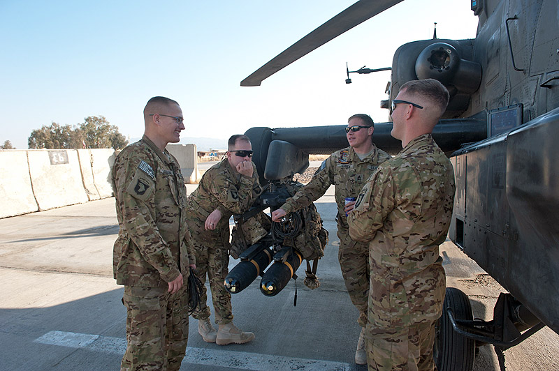 Apache crew chiefs with A Company, 1st Battalion, 101st Combat Aviation Brigade, Task Force No Mercy discuss hte day's work schedule next to an AH-64 Apache helicopter at Forward Operating Base Salerno, Afghanistan, Jan. 25, 2013. (U.S. Army photo by Sgt. Duncan Brennan, 101st CAB public affairs) Apache crew chiefs with A Company, 1st Battalion, 101st Combat Aviation Brigade, Task Force No Mercy discuss hte day's work schedule next to an AH-64 Apache helicopter at Forward Operating Base Salerno, Afghanistan, Jan. 25, 2013. (U.S. Army photo by Sgt. Duncan Brennan, 101st CAB public affairs)