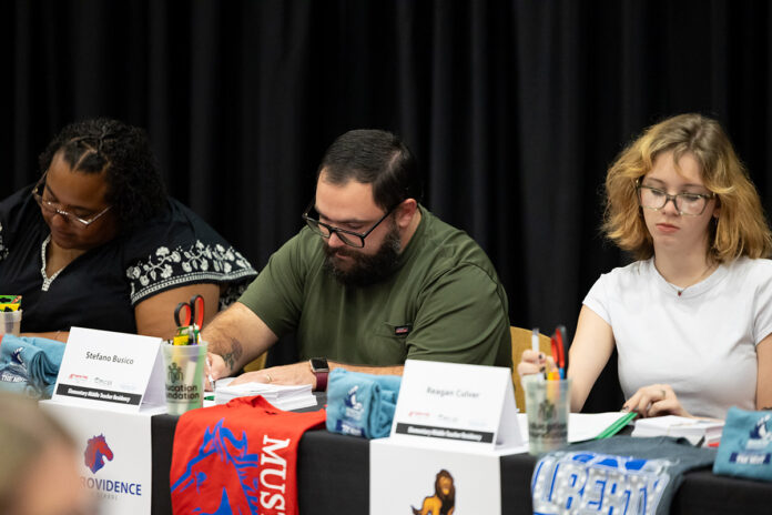 Stefano Busico (center), signs his Clarksville-Montgomery County School System teaching contract on July 27th, at Austin Peay State University. Busico is one of 23 CMCSS educational assistants entering the Grow Your Own Teacher Residency this year. (Sean McCully, APSU)