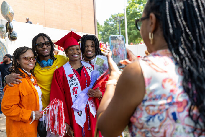 Denesia Stevens takes a photo with her loved ones on the Dunn Center’s front lawn after receiving her Bachelor of Science from Austin Peay State University in August 2025. (Robyn Jacobs, APSU)