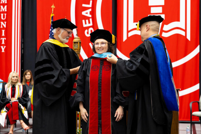 Dr. Brandi Stroecker is hooded by Dr. Philip Short and Dr. John McConnell before receiving her Doctor of Education from Austin Peay State University on May 8th. (Sean McCully, APSU)