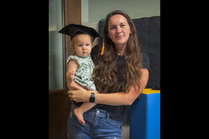 Lesley Mosqueda holds her daughter, Millie, after graduating from Blanchfield Army Community Hospital’s MOM and ME Group. The weekly support group provides breastfeeding mothers with peer encouragement, education, and access to certified lactation consultants throughout their baby’s first year. Families who complete the program receive a graduation certificate recognizing their breastfeeding journey. (Blanchfield Army Community Hospital, Justin Moeller)