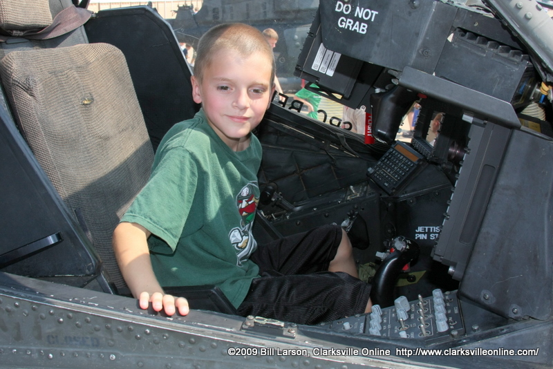 A child sits behind the controls of a helicopter A child sits behind the controls of a helicopter
