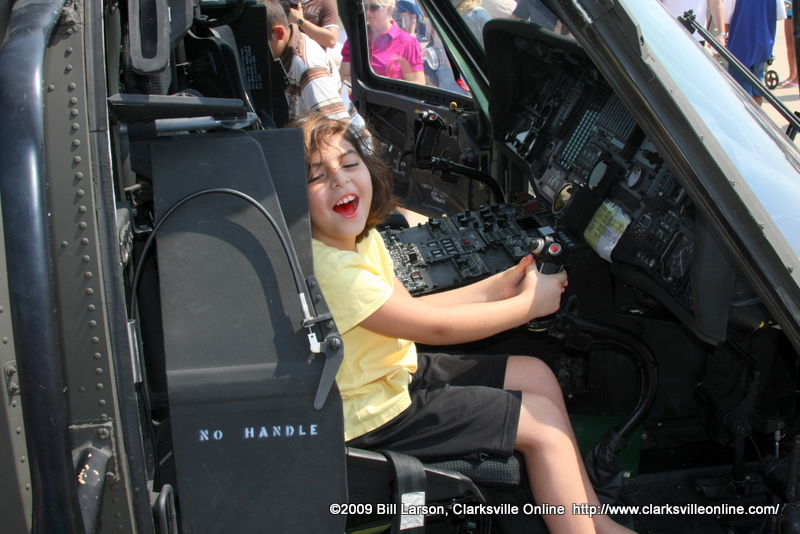 A child sits behind the controls of a helicopter A child sits behind the controls of a helicopter