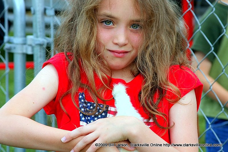 A young girl holds a baby chick at the petting zoo during the 2009 Kiwanis Club Rodeo A young girl holds a baby chick at the petting zoo during the 2009 Kiwanis Club Rodeo