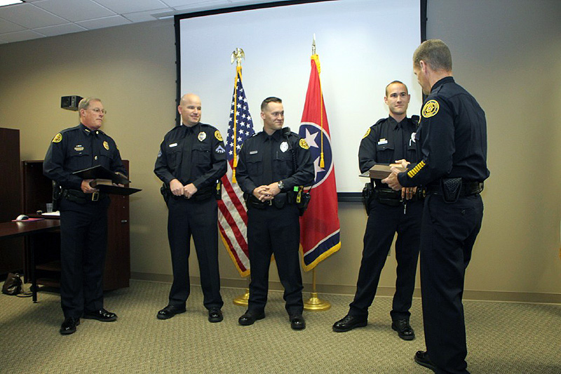 Chief presenting the Lifesaving Award to Officer Nathan Lee. (Photo by CPD-Jim Knoll) Chief presenting the Lifesaving Award to Officer Nathan Lee. (Photo by CPD-Jim Knoll)