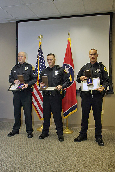 Officers Wilson, Danault, and Lee with their medals. (Photo by CPD-Jim Knoll) Officers Wilson, Danault, and Lee with their medals. (Photo by CPD-Jim Knoll)