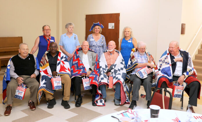 Quilts of Valor';s Dawn Wilcox, Sue Nelson, Rebecca Zuercher and Miriam Vance with this year's recipients